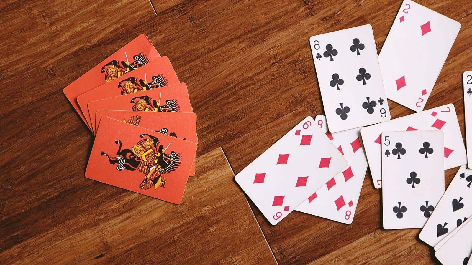Playing cards fanned out on a wooden floor