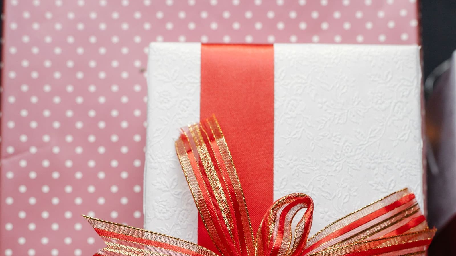 A wrapped gift with a red ribbon bow